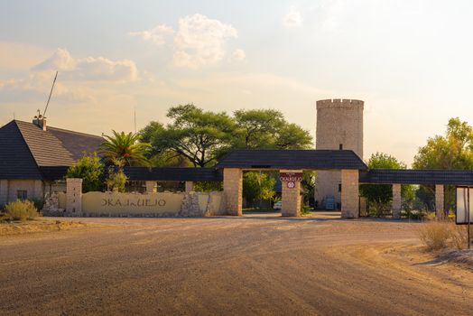 Okaukuejo, Namibia - April 2, 2019 : Entry gate of the Okaukuejo resort and campsite in Etosha National Park photographed at sunset.