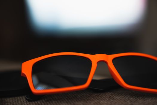 A pair of orange sunglasses close up
