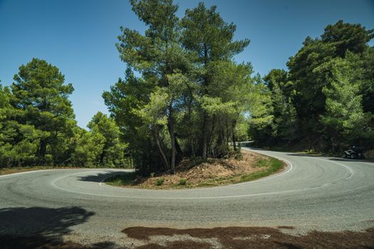 A hairpin tight corner on a road in the mountains in Greece