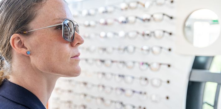 the glasses are selected and tested by a woman in an optics store.