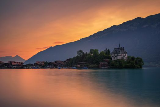 Sunset above Iseltwald peninsula and forme castle in Switzerland, now Rehabilitation Center of Seeburg. Long exposure.