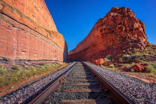 Railroad tracks going through a remote desert canyon near Corona Arch Trail in Utah