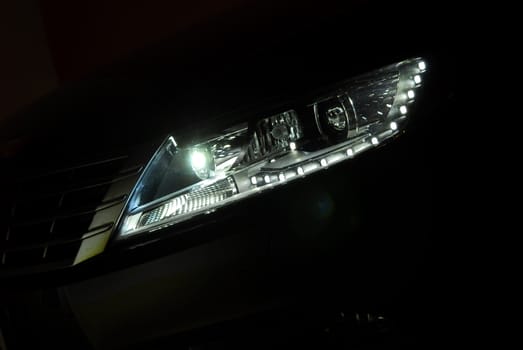 Closeup photo of a black car's headlight