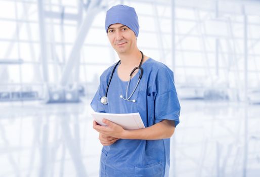 happy doctor with his notes at the hospital