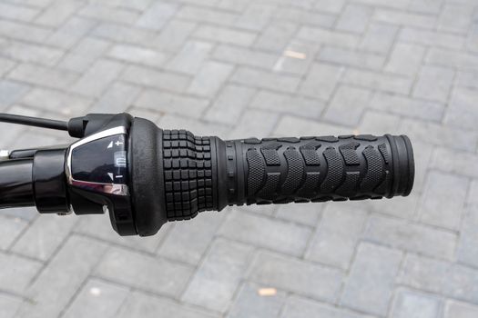 Close view of the right hand handle of a bicycle showing the gear changer