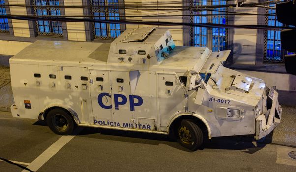 Police armored truck parked in front of a police station