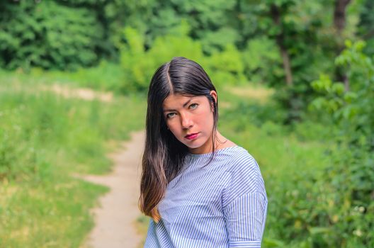 A photo of beautiful girl with black hair, green background