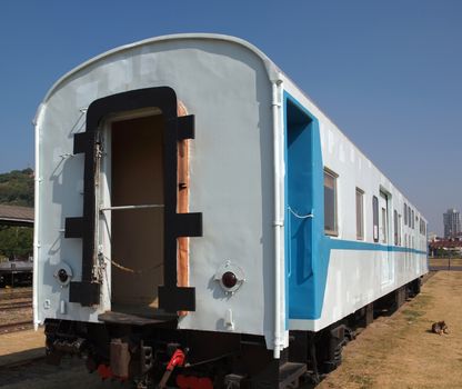 A vintage train carriage that has been freshly painted in light blue