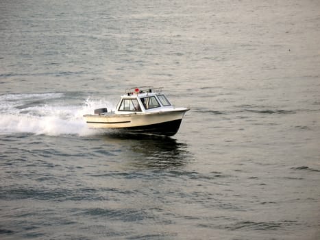 -- a harbor police boat speeding through the water
