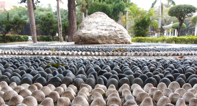 Chinese health walk made up from large pebbles in different colors
