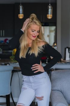 A gorgeous blonde model enjoys a day at home before work