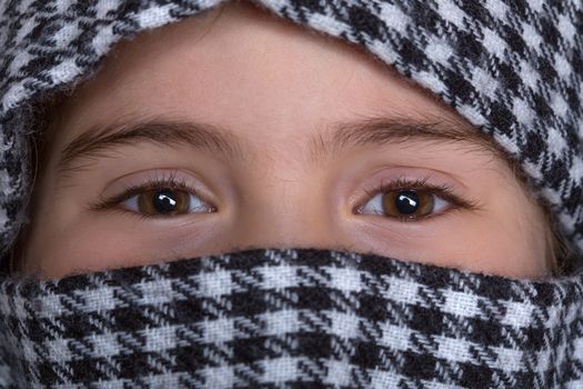 young girl with a veil covering her, close up, studio picture