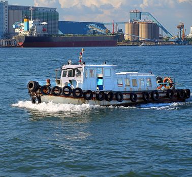 A small pilot boat makes its way through Kaohsiung port in Taiwan
