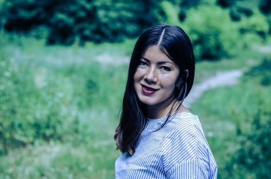 portrait of young gorgeous happy brunette in the park