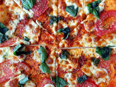 Oven baked pizza margherita with tomatoes, cheese and fresh basil
