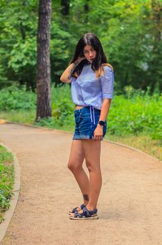 Young female brunette walking in the park