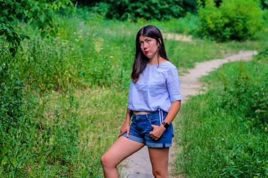 young happy teenage brunette girl at the park