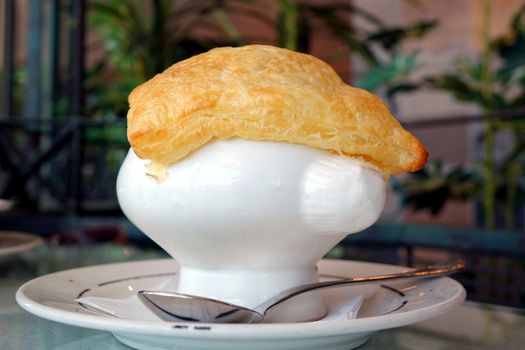 A soup dish with corn potage and crisp puff pastry
