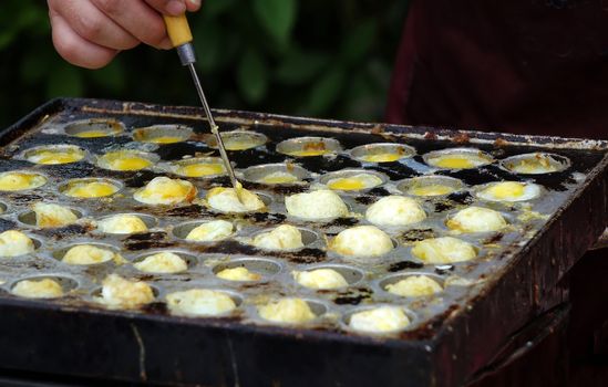 A street vendor cooks poached quail eggs, a popular snack in Taiwan
