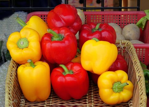 Colorful sweet or bell peppers are sold at a farmers market
