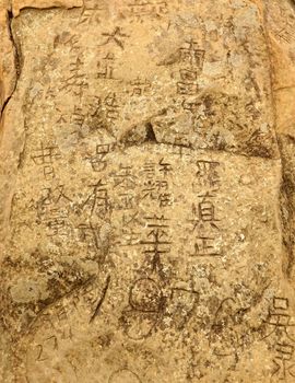 The rock surface on a mountain peak in Taiwan is damaged by graffiti carvings