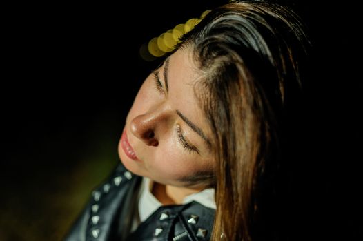 beautiful long black hair of a young girl on a background of night lights