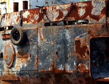 An old fishing boat that is decaying with rust