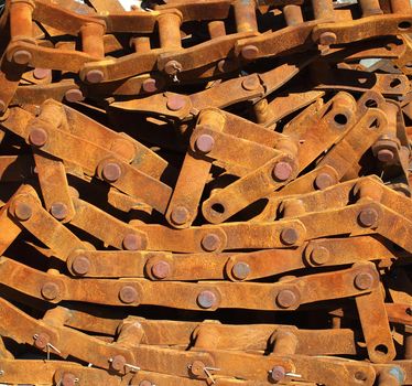 A rusty old chain link system that was part of a continuous track
