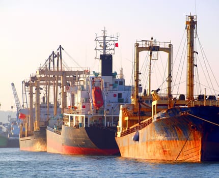 A row of cargo ships is anchored at Kaohsiung Port
