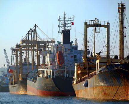 A row of cargo vessels is anchored at Kaohsiung Port