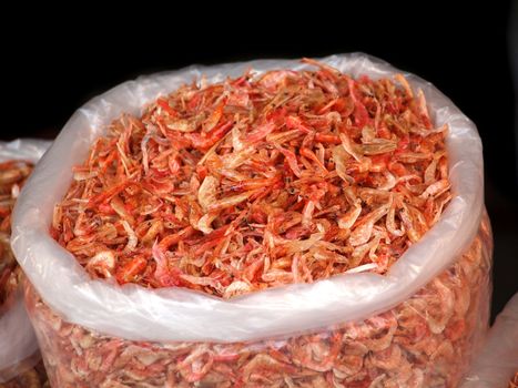 Large sack with dried shrimps for sale at an outdoor market