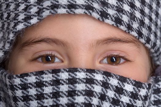 young girl with a veil covering her, close up, studio picture