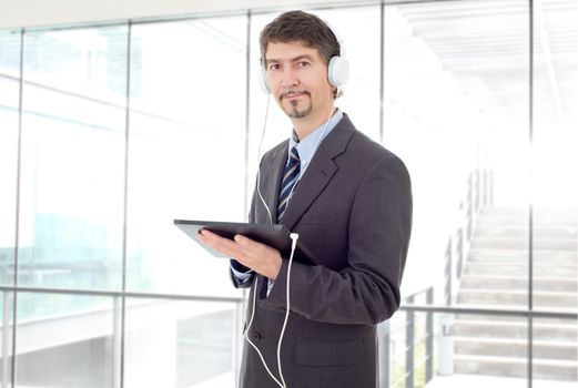 businessman with tablet pc and headphones, at the office