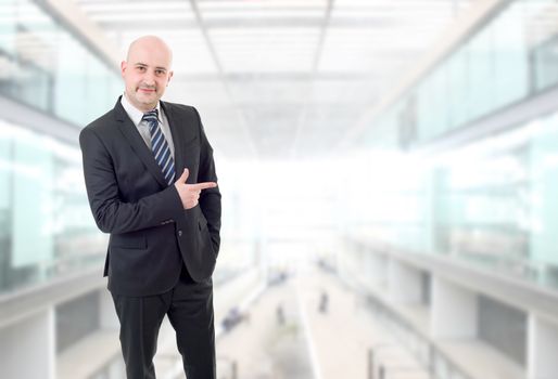 happy business man pointing, at the office