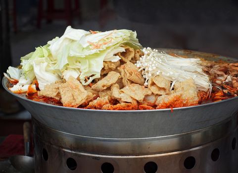 A Chinese stew type dish with cabbage, tofu and mushrooms
