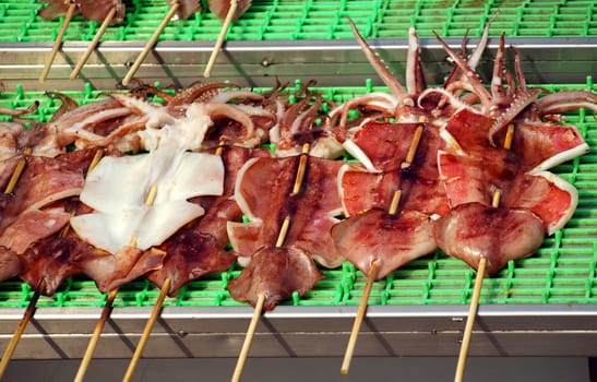 Squid on skewers is prepared to be grilled