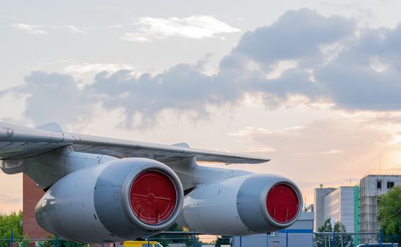 aircraft wing with engines in the Parking lot on the background of the city area