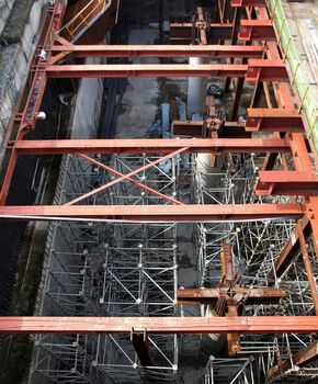 A large underground construction site with strong pillars and girders
