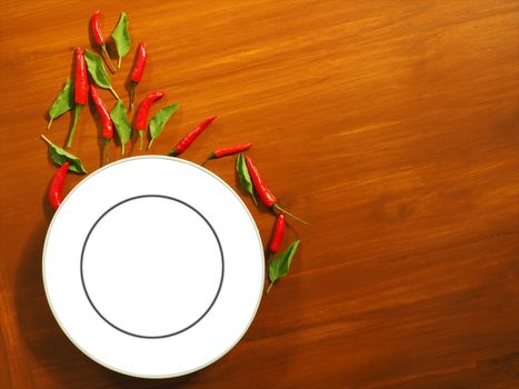 
White empty plate with chilies and basil The background is real solid wood.
Food show concept
Suitable for advertisement of food and display signs.