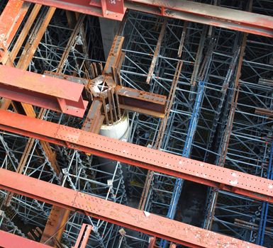 A large underground construction site with massive pillars and girders