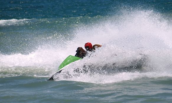 A personal watercraft makes a quick turn in the ocean