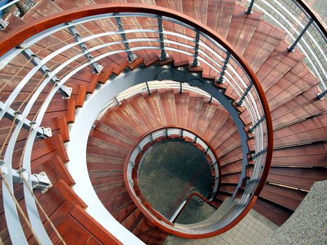 A winding staircase with steps made from wood