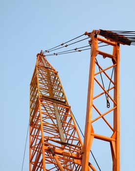 A powerful yellow crane at a construction site
