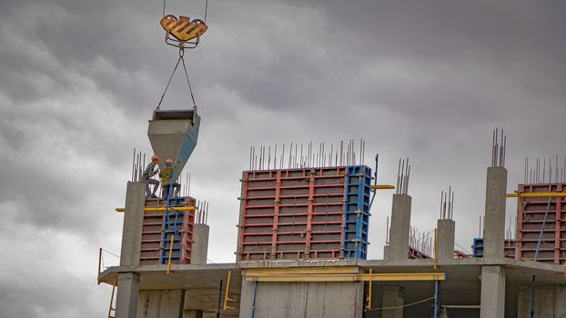 Pre-fabricated structures and products. The construction of a new building, skyscraper, or structure with the help of a crane. Construction of a multi-storey residential building.