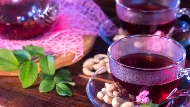 English tea. Red hot hibiscus tea in glass mug. Tea time: cup of tea, carcade, karkade, rooibos. Oriental, cozy, ceremony, tradition, japanese, leafy, hygge, autumn, 5 o'clock, afternoon