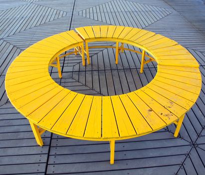A unique wooden bench in the shape of a circle
