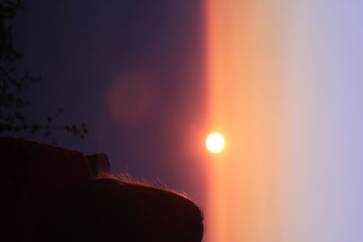 Women standing on the mountain watching the sunrise.