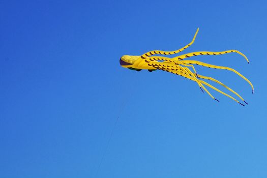 Yellow kite on a blue sky