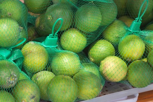 Stack of limes on display at market