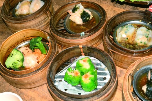 Chinese steamed dimsum in bamboo containers traditional cuisine